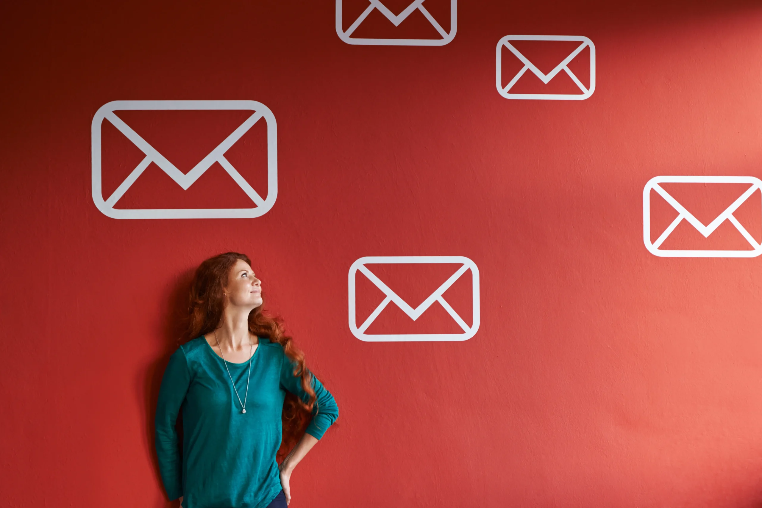 woman-looking-at-email-symbols-on-red-wall-2026-03-25-06-58-56-utc